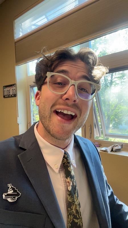 Photo of Staff member Laurent Beauregard wearing a suit and smiling