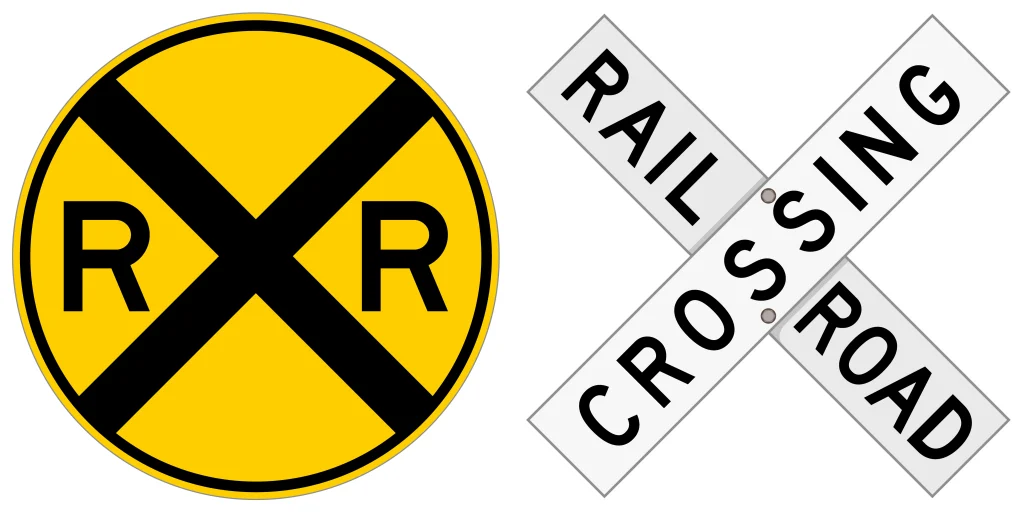 Two railroad crossing signs: a round sign and a crossbuck